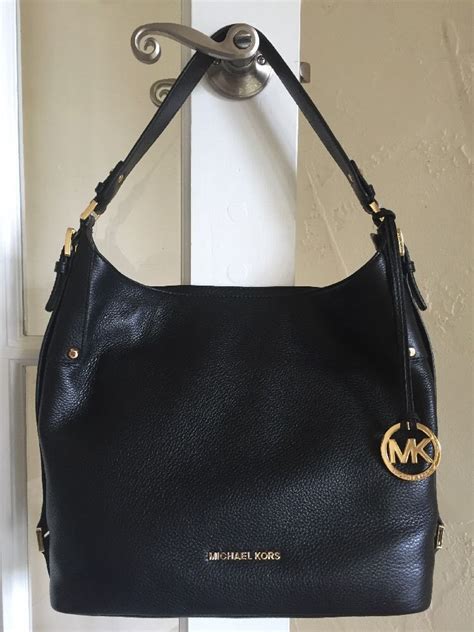 michael kors black leather handbag gold hardware|Michael Kors black signature handbag.